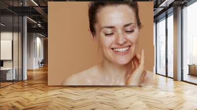 happy modern female with wet face washing Wall mural