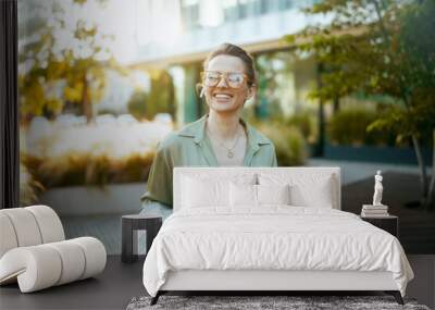 happy modern woman worker in green blouse and eyeglasses Wall mural