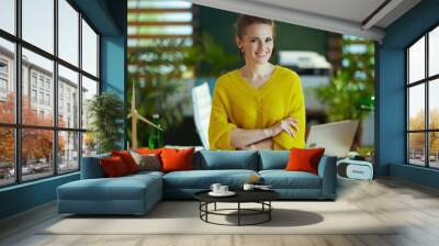 happy trendy business owner woman standing in green office Wall mural