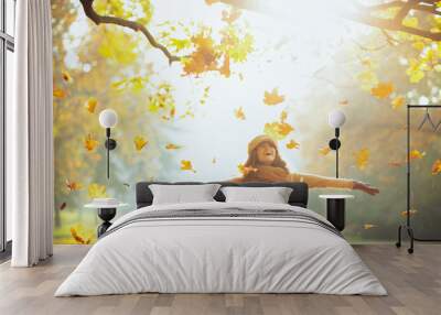 happy woman enjoying autumn and catching falling yellow leaves Wall mural