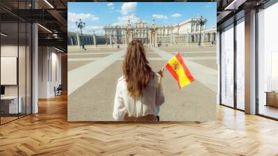 modern traveller woman with Spain flag against Royal Palace Wall mural