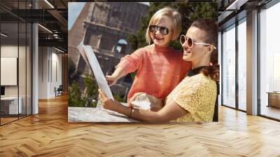 mother and daughter travellers in Rome, Italy pointing at map Wall mural