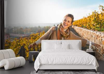 Portrait of happy young woman in autumn outdoors Wall mural