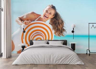 portrait of happy young woman in swimsuit with beach hat Wall mural