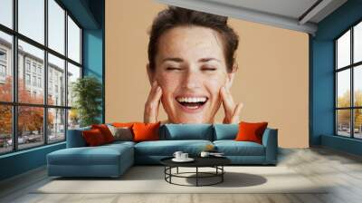 Portrait of smiling modern 40 years old woman with face scrub Wall mural