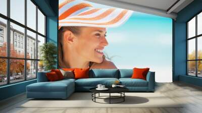 portrait of smiling woman in hat on beach looking on copy space Wall mural