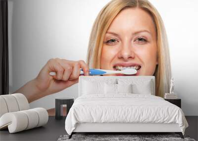 Portrait of teenage girl brushing teeth Wall mural