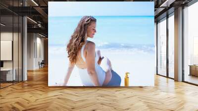 relaxed elegant woman sitting at beach Wall mural