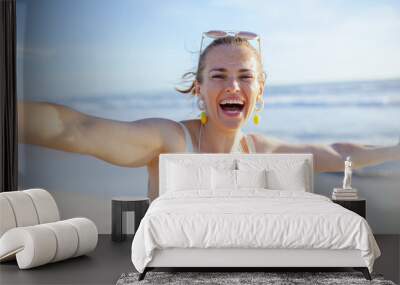 smiling 40 years old woman in swimwear at beach having fun time Wall mural