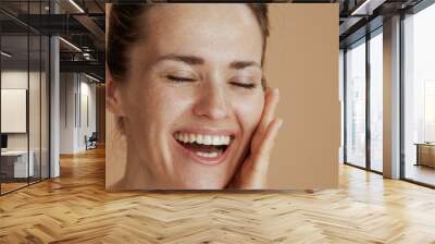 smiling modern female with wet face washing Wall mural