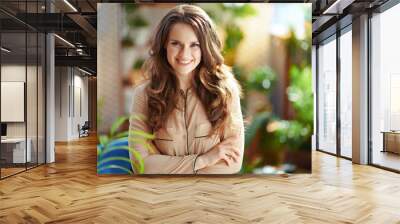 smiling trendy female with long wavy hair in sunny day Wall mural