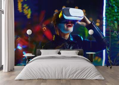 surprised trendy 40 years old woman in metaverse in vr goggles Wall mural