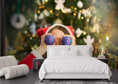 surprised woman using Christmas balls as eyes Wall mural