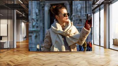 traveller woman in Milan with digital camera taking photo Wall mural