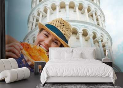 Woman biting slice of pizza by Leaning Tower of Pisa Wall mural