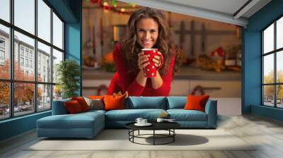 Young woman having christmas cookies in kitchen Wall mural