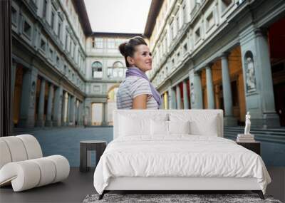 young woman standing near uffizi gallery in florence, italy Wall mural