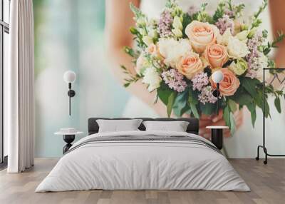 Close-up of a woman holding a beautiful bouquet with a blurred background. Wall mural