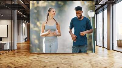 Couple, running and fitness communication in nature park for exercise wellness or interracial training workout. Health conversation, runner motivation and diverse friends, talking on cardio run Wall mural