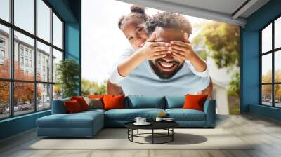 Fun father playing with his young daughter on his back in their family home garden bonding together. Small child laughing and enjoying happy, silly childhood lifestyle with loving parent Wall mural