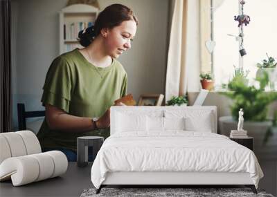 I need to buy this. Cropped shot of an attractive young businesswoman sitting alone in her home office and using her laptop for online shopping. Wall mural