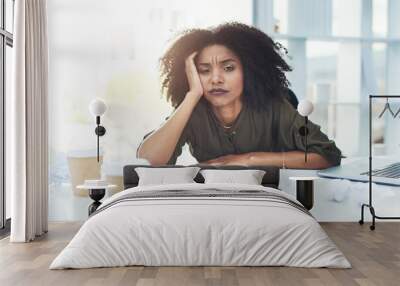 Running out of ideas is normal, just never give up. Portrait of a young businesswoman sitting at her office desk looking tired and stressed out. Wall mural