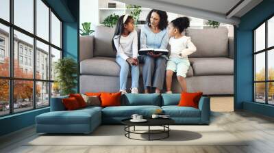 Senior family reading books to children, teaching and learning bible story, questions and education in living room. Grandmother and kids on sofa with storytelling or holy religion, knowledge and help Wall mural