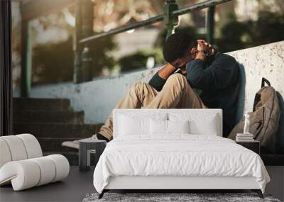 Student, mental health and depression with anxiety, burnout and sad for exam results, fail or mistake while sitting outdoor. Young man, stress and tired and depressed on university or college campus Wall mural