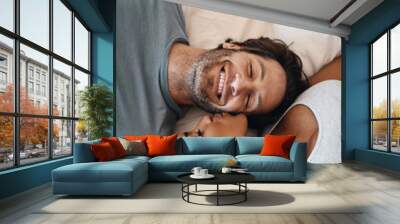 Youre the reason for my happiness. Cropped shot of a happy young couple lying in bed together. Wall mural