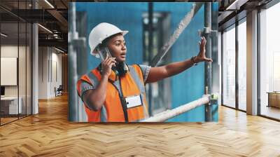 Construction worker talking on a phone call while standing in an empty building. Professional builder discussing plans and strategy, checking the inside structure. Civil engineer doing a safety check Wall mural