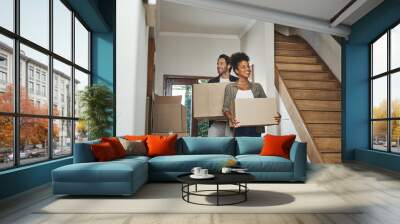 Excited, happy and young couple moving into a new home together while carrying and packing household boxes. Smiling, positive and cheerful husband and wife in a lovely modern real estate property Wall mural