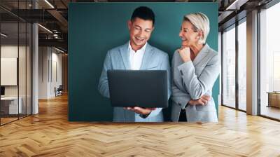 Laptop, teamwork and planning with a business team in studio on a green background for strategy. Computer, collaboration or management with a man and woman working on growth as company leadership Wall mural