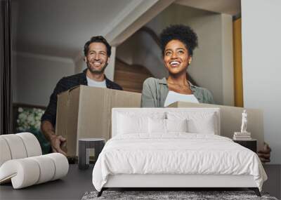 New house, moving and happy couple carrying boxes while feeling proud and excited about buying a house with a mortgage loan. Interracial husband and wife first time buyers unpacking in dream home Wall mural