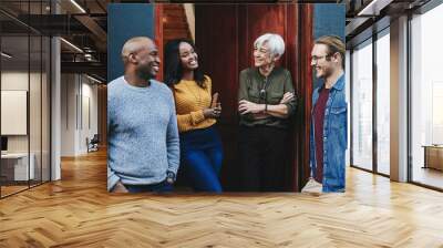 These chats always inspire us to do better. Shot of a group of businesspeople having a discussion together while standing outside their office building. Wall mural