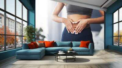 You gotta show love to your body. Cropped shot of an unrecognizable young woman making a heart shape on her stomach in her bedroom. Wall mural