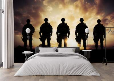 Silhouette of armed soldiers or marines in a row. Sunset..War concept. Wall mural