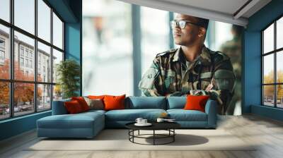 Confident soldier thinking, mockup and arms crossed in army building, pride and professional hero service. Military career, security and courage, black man in camouflage uniform at government agency. Wall mural