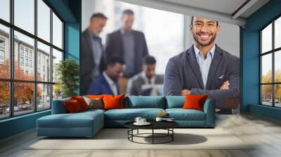 i call my own shots. portrait of a young businessman at the office standing in front of his colleagu Wall mural