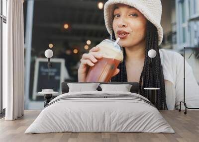 Woman, smoothie and portrait outdoor at a restaurant and drink from cafe with a smile. Milkshake, coffee shop and gen z fashion of a female person drinking from a straw on break on diner patio Wall mural