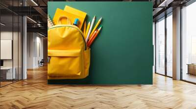 Welcome back to school. A new yellow school bag on isolated dark green background, back to school concept Wall mural