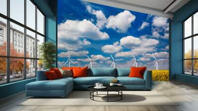 Wind turbines in a field under blue skies Wall mural