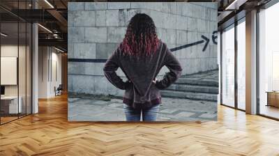 Young girl in front of a wall painted Wall mural