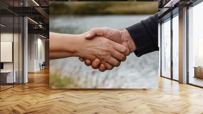 Close-up of Two Hands Shaking Outdoors Wall mural