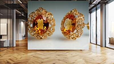 Close-up of a Pair of Golden Earrings with Orange Gemstones Wall mural