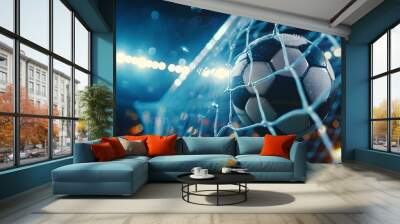 Dramatic night soccer goal with wet ball in net under bright stadium lights Wall mural