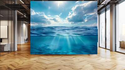 Blue sea or ocean water surface and underwater with sunny and cloudy sky Wall mural