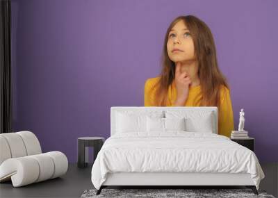  Emotional cute little girl on violet background Wall mural