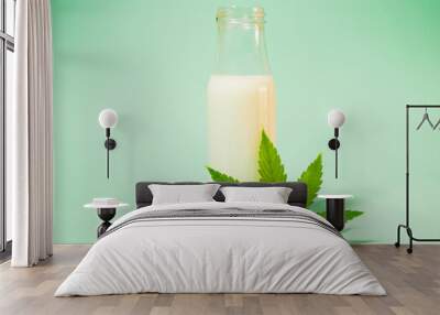 Hemp milk in the bottle. Cannabis leaf. CBD infused. Healthy plant based vegan beverage.  Wall mural