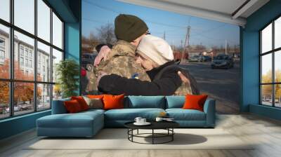 Elderly mother says goodbye to her military son. Mom hugs a Ukrainian soldier. Militarization. Ukrainian defender says goodbye to his family. Mobilization of Ukrainian men. War of Ukraine and Russia Wall mural