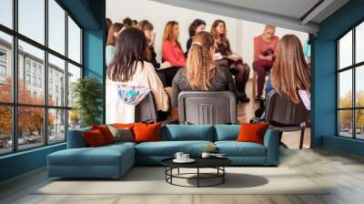 Group of young women talking sitting in a circle. Psychological support Wall mural